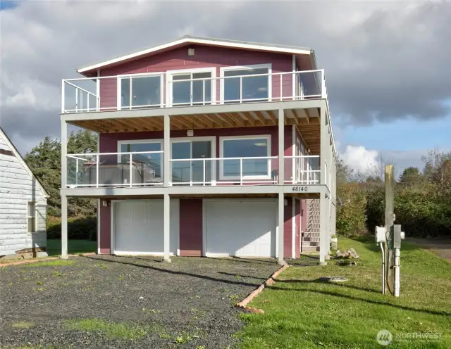 This property is very unique.  It was built to have an upstairs and downstairs unit but flow easily to be connected as one, so you choose! Walk to the right of the garage and up a flight of stairs to a shared entry. The glass railing will protect you from the coastal breeze as you sip your favorite beverage and take in the view.