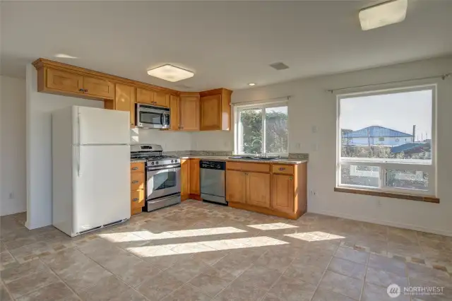 The kitchen has a propane stove and stainless appliances. Washing the dishes from this home includes a sunny south facing view window.