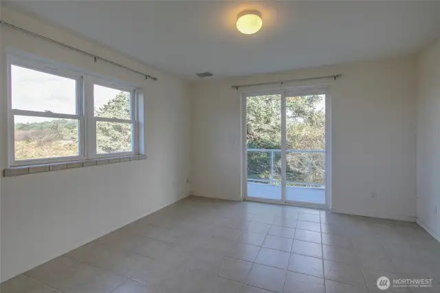 Lower unit guest bedroom with walk out. This wrap around deck connects you to the oceanside deck with hot tub.