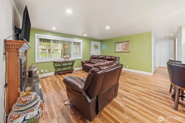 Living room has beautiful Fireplace and lots of natural light
