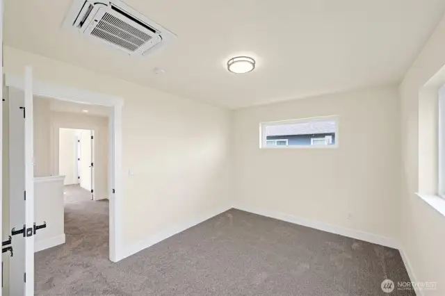 Another view of the bedroom with recessed mini-split in the ceiling.