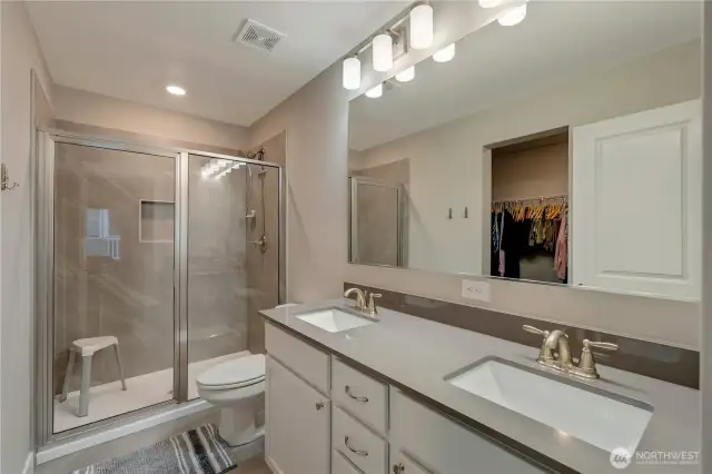 Primary bathroom with beautiful shower and double sinks.