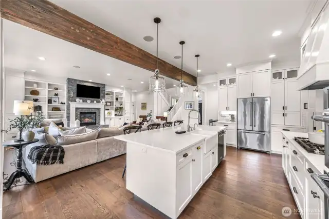 Another view of kitchen into great room. Kitchen with farm sink, natural gas cook top and hood. This kitchen will please the cooks in the group.