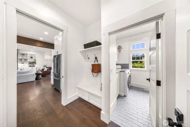 Laundry room with tile floors plus back door coat and shoe rack.