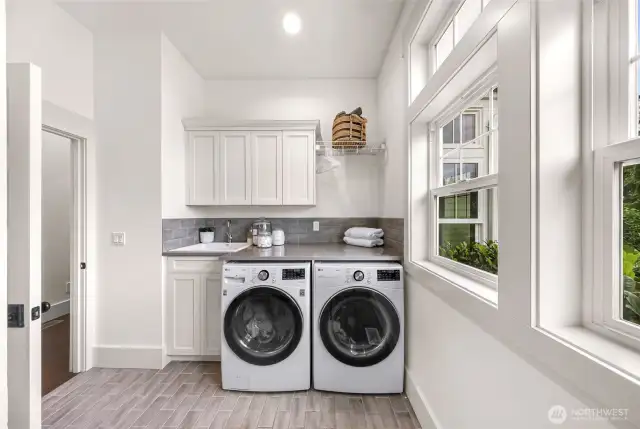 Laundry with ample amount of cabinets and sink. Also more windows for lots of natural light.