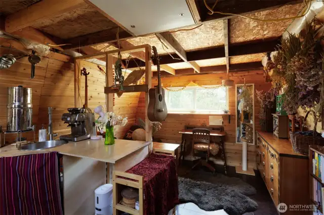 Interior with sink and counter space, looking through to cozy living space.