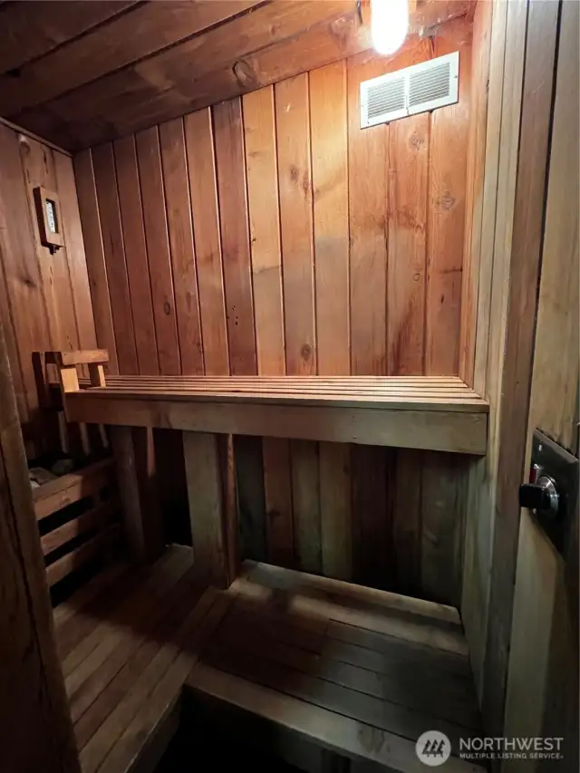 Immaculate cedar sauna within garage storage room