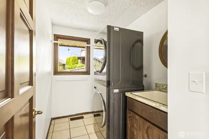 Laundry room with sink and newer washer and dryer and gas hook up
