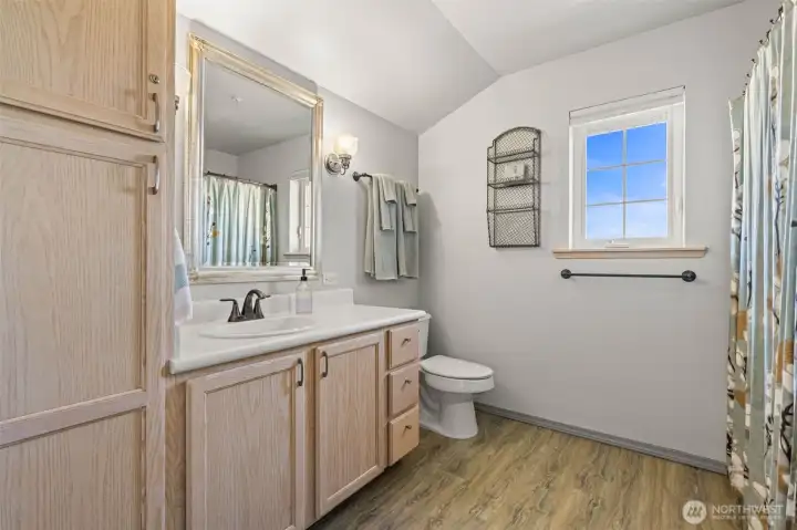 Primary bathroom with ample storage and large walk-in shower