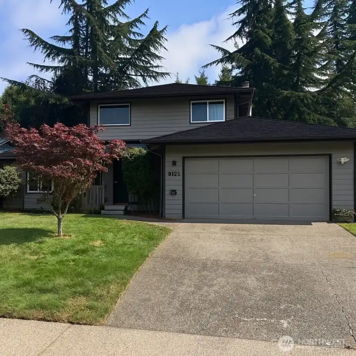 Beautiful craftsman home with two car garage, mature landscaping and on quiet street.