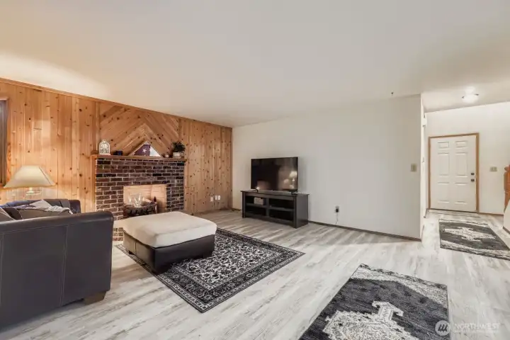 The informal living room, warmed by a gas fireplace, just off the kitchen.