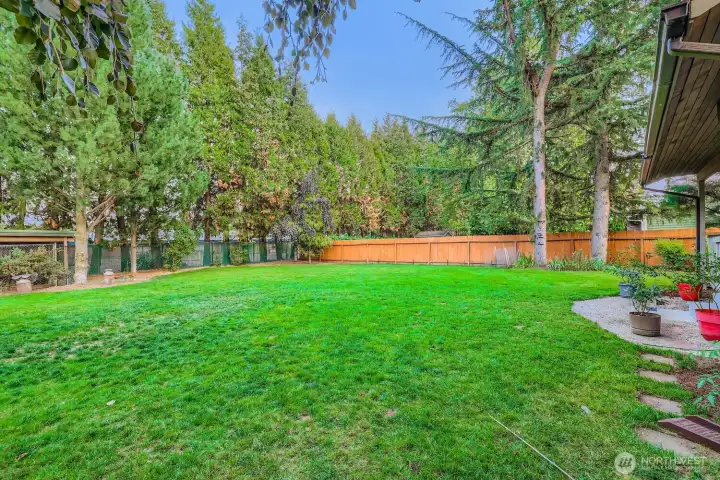 Another view of the spacious back yard and mature landscaping.