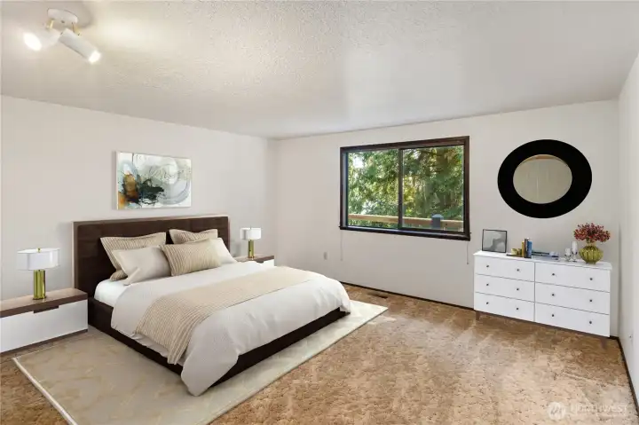 The primary bedroom is spacious and faces east, with a peek-a-boo water view.