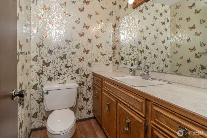 The powder room on the main level is conveniently located by the garage door, and down the hall from the main living area.