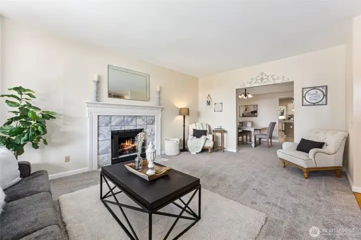 Luminous formal living room just off the foyer offers warmth and elegance with a gas fireplace.