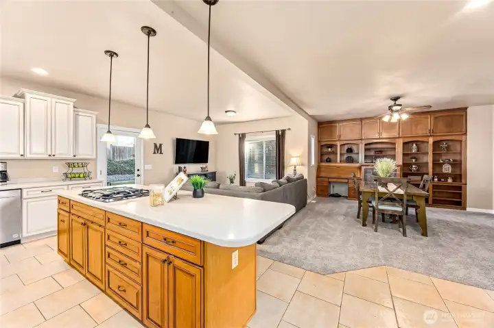 The inviting kitchen opens to the family room and additional dining or expanded family room space, offering a flexible, open layout ideal for living and entertaining.