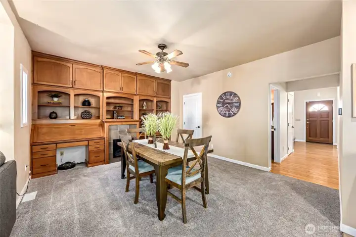 This versatile flex space, adjacent to the kitchen and family room, can serve as extra dining, a cozy sitting area, or expanded family room, complete with built-in cabinetry and an electric fireplace.