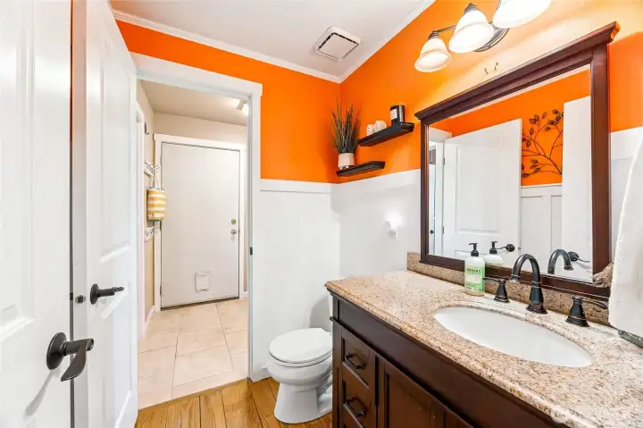 Convenient main-floor powder room, accessible from both the main hall and utility room.