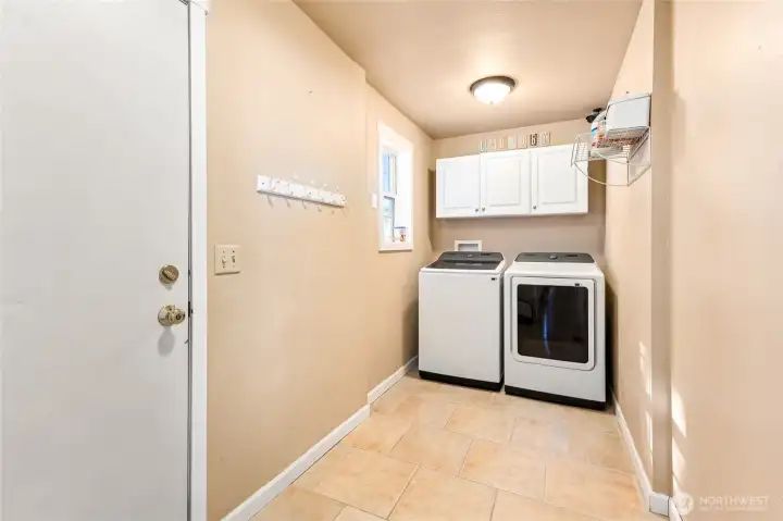 The utility room, with newer washer and dryer included, is strategically located just off the garage.