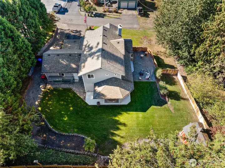 Aerial perspective showcases the rear yard of this generous .37-acre lot with abundant space for play, parties, pets, and more.