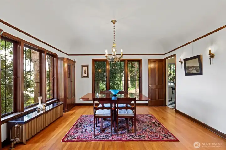 “Elegant dining room featuring the original chandelier and wall sconces, highlighting the home’s historic charm and classic architectural details.
