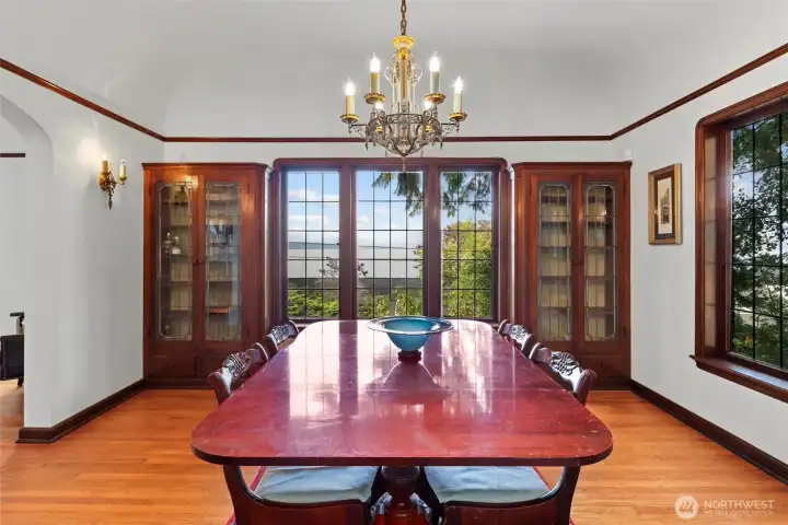 Oak built-ins and leaded glass doors that beautifully frame the home’s leaded glass windows, combining historic charm with elegant design.