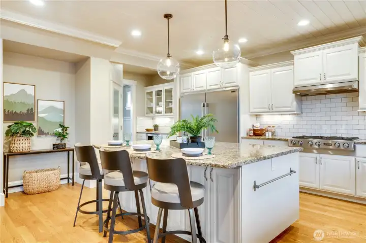 Built-in storage in the island makes it easy to keep all your kitchen gadgets organized. A spacious walk-in pantry across from the refrigerator adds even more convenience to this well-designed space.