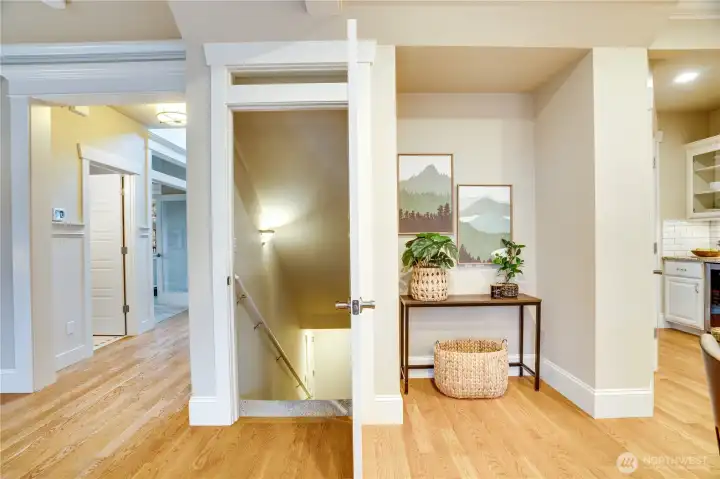 Notice the transom window above the doorway leading to the stairs that take you down to the finished basement and the roomy three-plus car garage. The nook to the right would be an ideal spot for a small desk, perfect for meal planning.