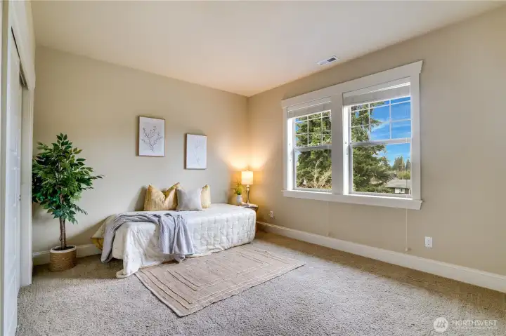 Each bedroom is roomy and bright with plenty of natural light, and the closets feature handy organizers. The fully wood-wrapped trim around the windows and closet, along with deep baseboards, adds a touch of lasting quality to the home.