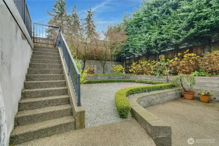 This low-maintenance space offers plenty of ways to enjoy it. The trees give cool shade, the hedges create privacy, and the sprinkler system keeps everything lush and green.