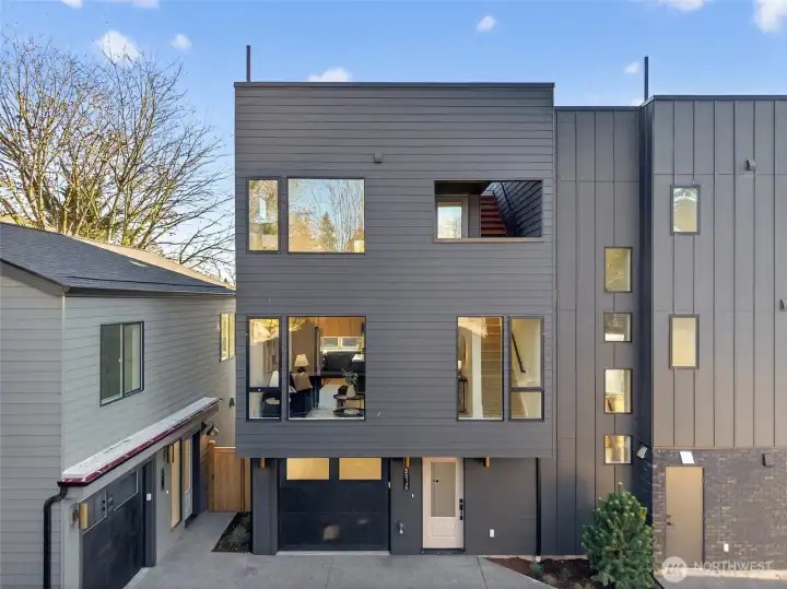 Welcome to your new construction home with a garage and rooftop deck views of Mount Rainier and Husky stadium.