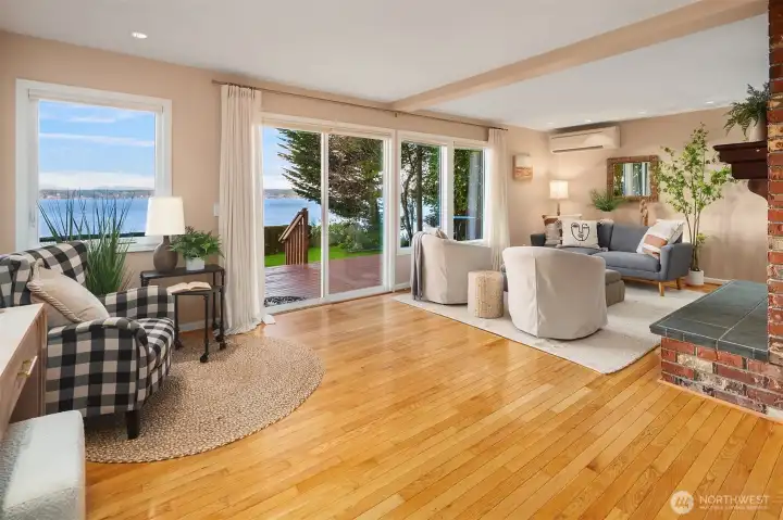 Living room with direct deck access and water views.
