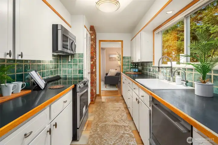Kitchen includes updated faucet, sink, and hot water tap.