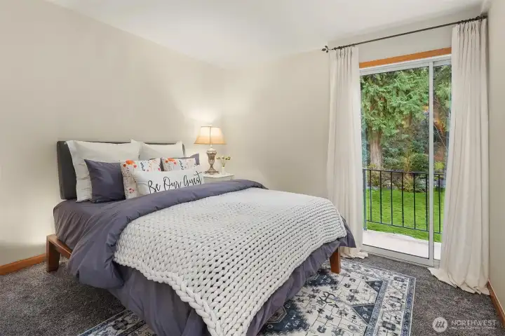 Guest bedroom updated with new paint and carpet with direct access balcony.