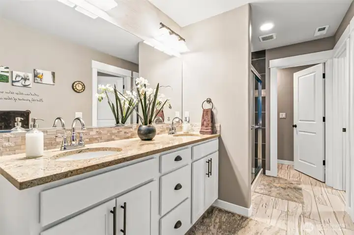 Double sink vanity in primary bath & timeless tile throughout.