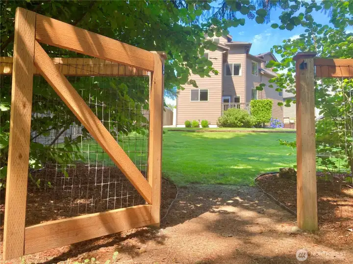 Expansive , fully fenced backyard with private gate access to the wooded area seasonal creek.