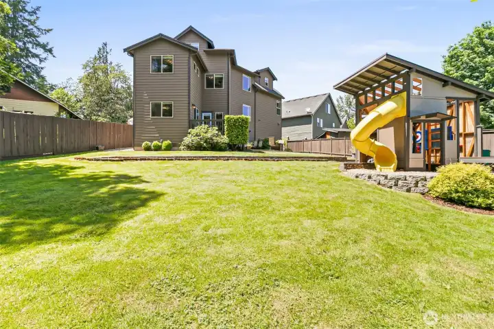 Large, level backyard with beautifully maintained lawn & room for play, entertaining, or relaxing outside!