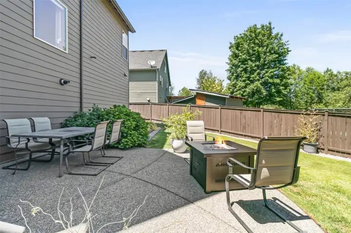 Patio leads to some garden beds with beautiful hydrangeas & room for gardening!