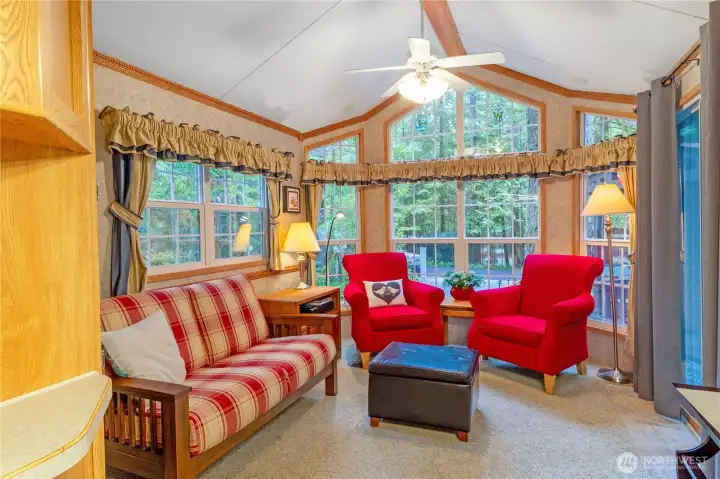 Living room sitting area w/ forest views.