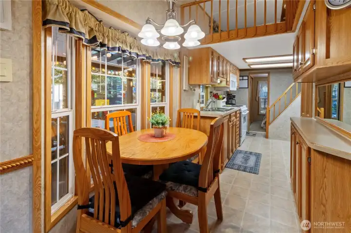 Dining area w/ large windows bringing in natural light.