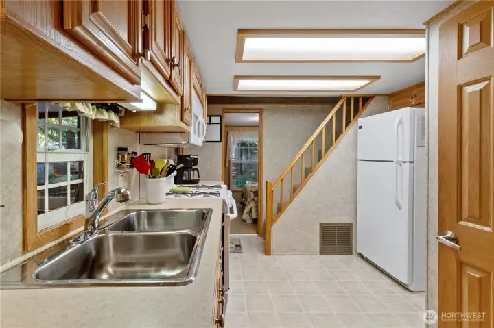Kitchen w/ double sink & ample cabinetry.
