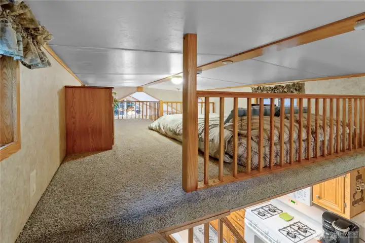 A view across the loft to the second area above the living room.