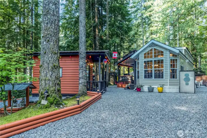 Exterior showing park model, shed & landscaped yard.