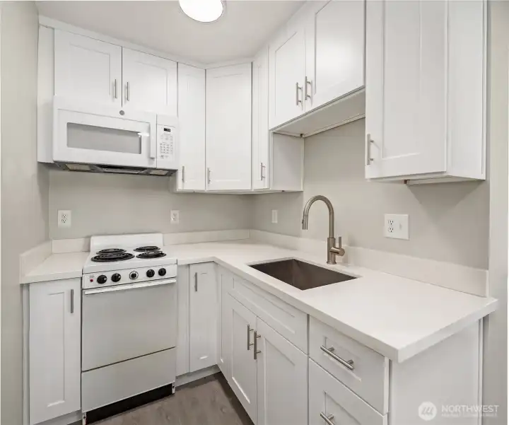 Kitchen with new white shaker cabinets and quartz cabinets