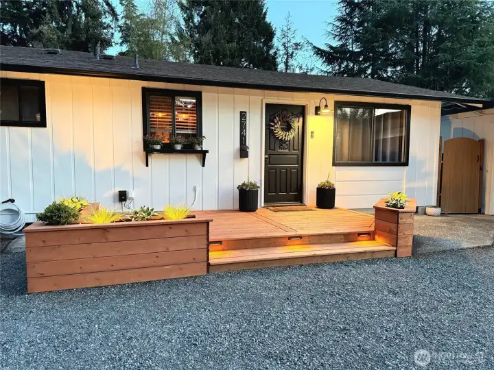 Custom lighting beautifully illuminates the entry.