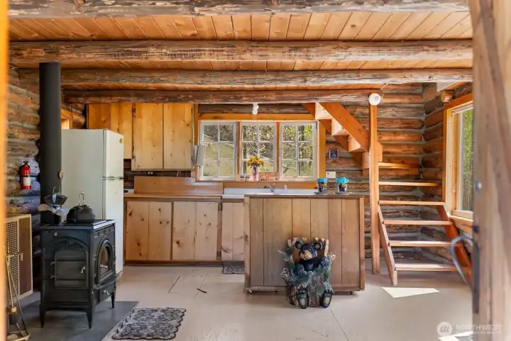 North facing Kitchen window. Pine cabinets. Freestanding wood fireplace. Keeps you toasty warm.