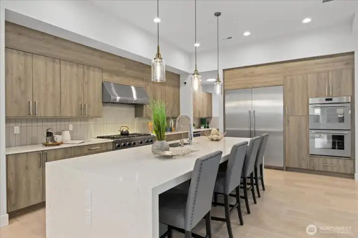 The chef’s kitchen is a true centerpiece with a large island, premium Thermador appliances, 48” gas range, double ovens, 60” integrated refrigerator, wine chiller, water filtration system, and high-end cabinetry in this Kirkland North Rose Hill luxury home.