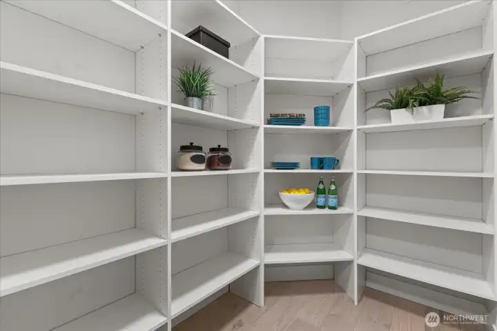 A spacious walk-in pantry with abundant built-in shelving provides the storage buyers want, adding everyday function to this beautifully designed Kirkland chef’s kitchen.