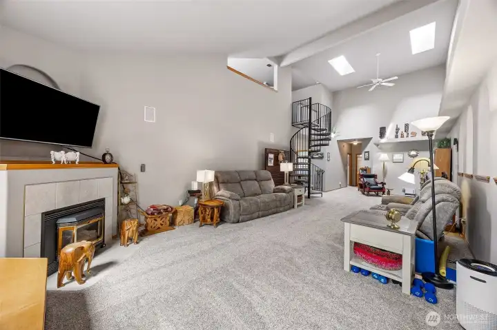 Living Room featuring vaulted ceilings & skylights.