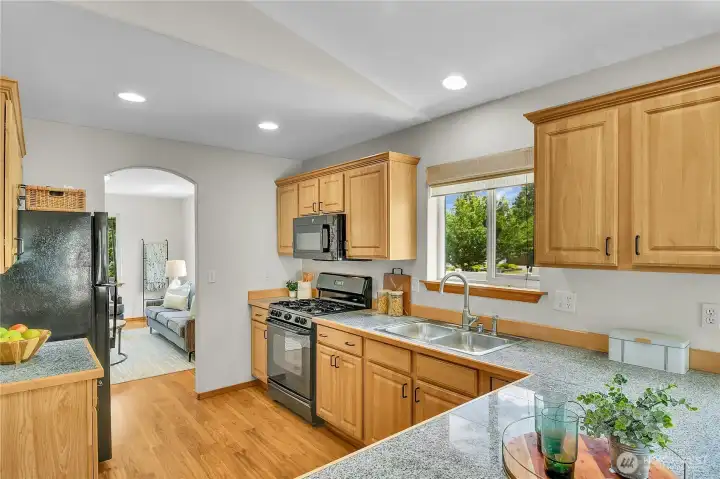 Open kitchen with stone counters- all appliances stay! New interior paint throughout! Open kitchen with stone counters- all appliances stay! New interior paint throughout!